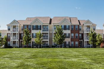an image of an apartment building on a green lawn at Brickshire Apartments, Indiana, 46410